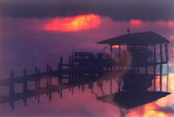 Patuxent River sunset with reflections on a calm river. Image