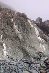 Metamorphic rocks smoothed by the surf at West Quoddy Head. Image