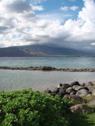 Lava boulders and enclosed Hawaiian fish pond - early form of aquaculture. Image