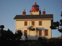 Yaquina Bay Lighthouse illuminated by the late afternoon sun. Photo