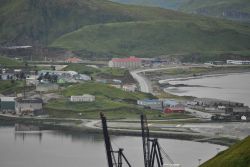 Looking over the American President Lines container cranes to the end of the Dutch Harbor Airport runway and the Grand Aleutian Hotel. Photo