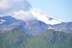 Looking towards Makushin Volcano over the green mountains of Unalaska Island. Image