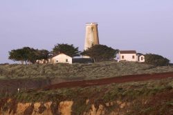 Looking north to the Point Piedras Blancas lighthouse from the top of the cliffs leading to the sea. Photo