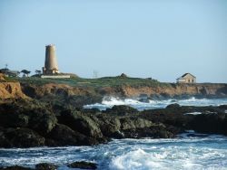 Looking south to the Point Piedras Blancas lighthouse over the shoreline at a high tide Photo