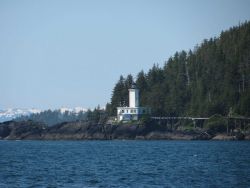 Cape Decision Lighthouse seen from offshore. Image