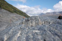 Metamorphic rock with glacial striations angled at about 30 degrees to the layering of the rock. Image