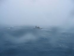 Inflatable boat waiting for retrieval by contract vessel CASITAS on a squally day. Image