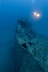 Diver with lights approaching the bow of the NORTHERN LIGHT, a shipwreck in 190 feet water depth Image