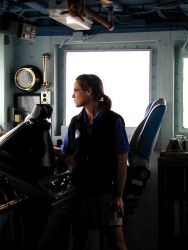 Lieutenant Commander Stacy Birk on bridge watch on the NOAA Ship McARTHUR. Image