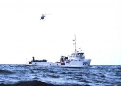 NOAA Ship FERREL working off Savannah with helicopter support. Image