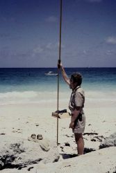 Lieutenant Dale Ross holding rod during tidal leveling operations Image