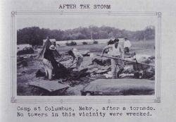 Cleaning up after a tornado hit the camp in Columbus Image