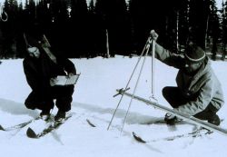Forest Service employees measuring snow depth Image