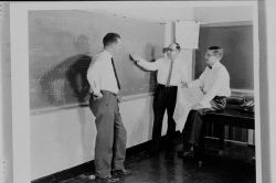 Weather Bureau employees discussing some weather theory Image