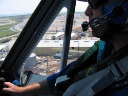 LT Phil Eastman hovering over damaged oil tank. Image