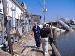 Wayne Weikel inspecting damage to fisheries infrastructure following Hurricane Katrina. Image