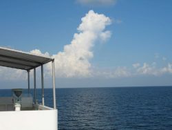 While the TAO buoy streams aft, innocent looking clouds approach Image