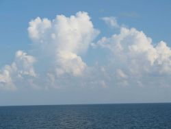 While the TAO buoy streams aft, innocent looking clouds approach Image