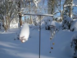 Wind chimes covered by snow. Image