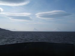 Wave clouds over the Islands of the Four Mountains. Image