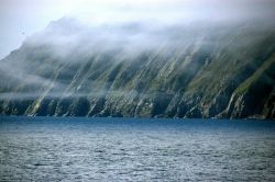 Wisps of fog appear like garlands over Little Diomede Island. Image