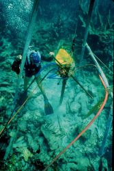 Coring into a coral reef to discover clues to past climate changes. Image