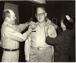 Captain David Whipp having his captain's eagles pinned on by Major General Harry H Image