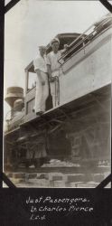 Lieutenant Charles Pierce and Ensign Leonard Johnson as passengers on a logging train in British Northwest Borneo during fueling stop in Sandakan. Image