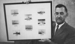 CAPT Raymond Stone with retirement gift of framed photos of all USC&GS ships upon which he served. Image