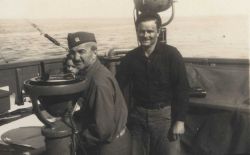 Commander William Malnate behind alidade, W Image