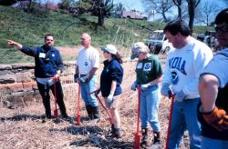 Glenn Page instructing volunteers in the art of wetland planting techniques at Ft Image