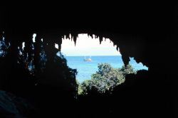 Looking out at the M/V El Alborada from inside the cliffs at Mona Island at the east end of the island. Image