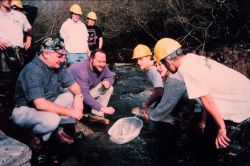 Jim Bybee and Rick Wantuck of NOAA examine small steelhead trout in the creek. Image