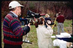 A NOAA contract videographer, Tom Kane, documents the soil testing process and videotapes the student's documentary production efforts. Image