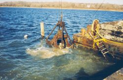 Lowering the reef materials into the water to construct the reefs. Image