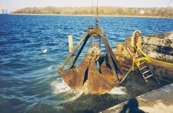 Lowering the reef materials into the water to construct the reefs. Image