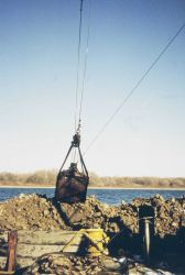 Lowering the reef materials into the water to construct the reefs. Image