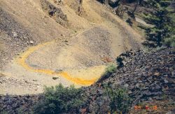 Contaminated drainage coming out of a mine adit. Image