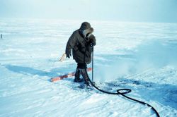 Using a boiler to melt the permafrost for setting a triangulation marker Image