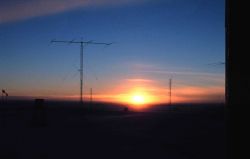 South Pole Station antenna farm illuminated by setting sun Photo