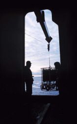 Deploying the Conductivity/Temperture/Depth (CTD) and rosette water sampler through the baltic room door of the NATHANIEL B Image