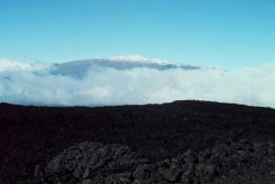 Each day the cloud cover rolls up Mauna Loa from the Hilo area Image