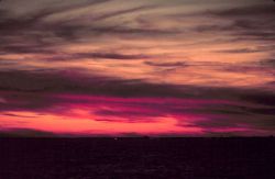 Lurid colors mark a sunrise at sea off the eastern seaboard. Photo