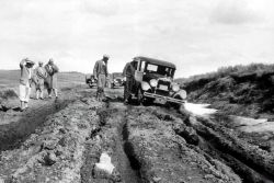 1925 automobile stuck in dirt road Image