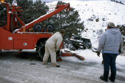 YPSS (Yellowstone Park Service Stations) tow truck pulling a pickup out of the Gardner River Image