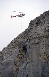 Unloading explosives on Sheep Cliff, to be used to remove unsteady rock after a rock slide Image