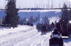 Snowmobiles & exhaust in the winter at the West entrance road on Presidents Day weekend Photo